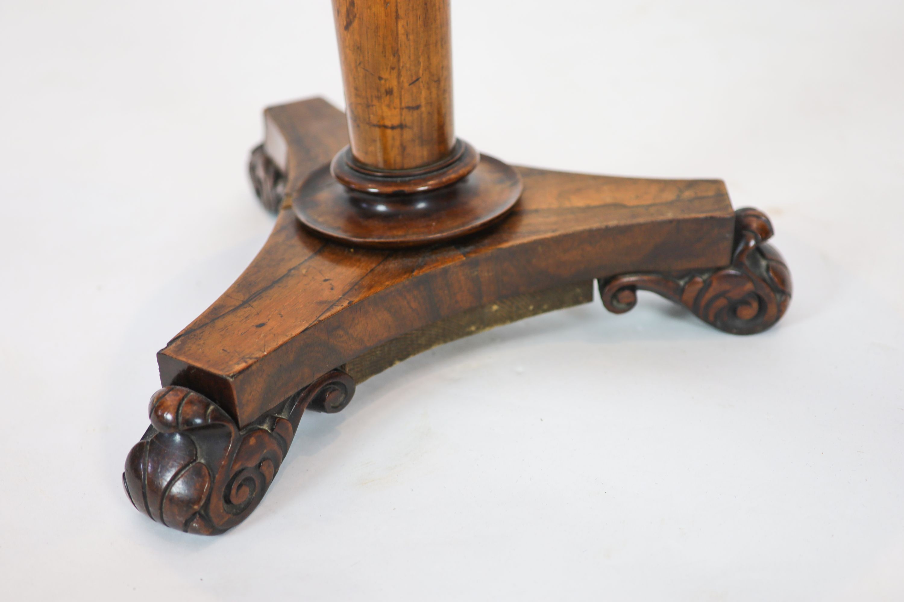 A Regency banded rosewood circular topped work table, raised on tapered, turned pillar, on a triform platform base, diameter 40cm, height 75cm